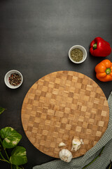 wooden cutting board on dark countertop