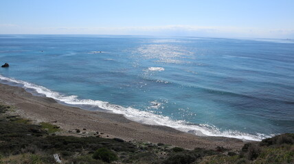 Scenic beach and rock formations in Cyprus. Mediterranean Sea, road, travel, view of mountains and sea.