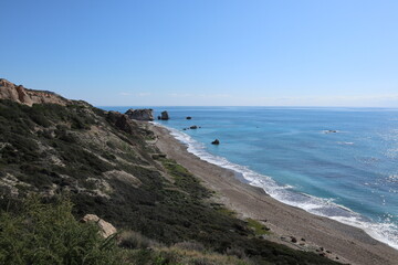 Scenic beach and rock formations in Cyprus. Mediterranean Sea, road, travel, view of mountains and sea.