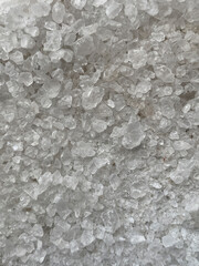 Close-up texture of coarse rock salt crystals with irregular shapes
