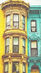 Fototapeta premium Colorful urban townhouses, bay windows, city street. Real estate, architecture, travel