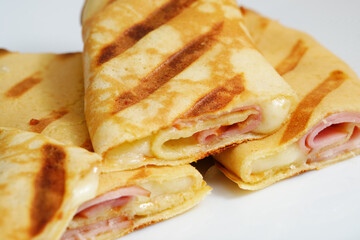 Grilled crepes with ham and cheese