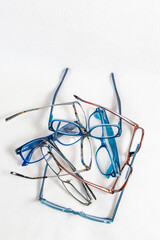 A stack of reading glasses isolated on a white background