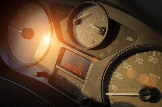 Close-up of car dashboard in sunset light with odometer reading "5555" and  trip computer showing "55". Repeating digits like "3", "7", or in this case "5" often considered lucky and people love it.