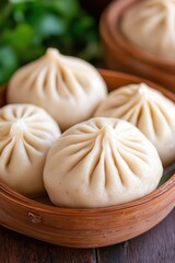 A bamboo steamer filled with fluffy dumplings, showcasing their intricate folds, set against a backdrop of fresh herbs.
