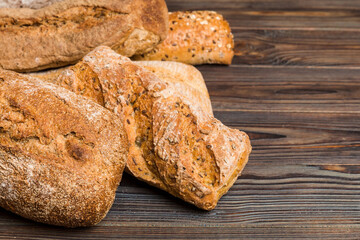 Homemade natural breads. Different kinds of fresh bread as background, perspective view with copy space