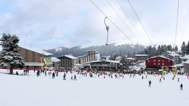 People skiing and chairlift at Uludag ski resort during winter holiday. Bursa, Turkey
