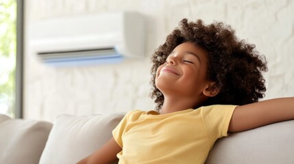 Naklejka premium Happy child enjoying comfort and relaxation in living room with air conditioning, bright lighting, and cozy atmosphere while resting on a sofa