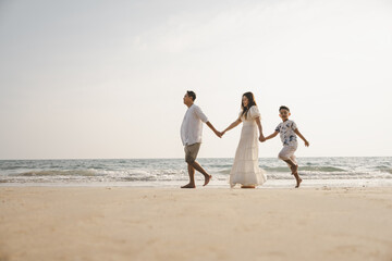 Asian family beach vacation. Children parent relax together. People lifestyle.