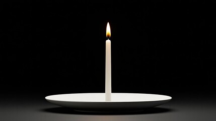 A lit candle stands on a white plate, casting a soft glow against a dark background, creating a serene and tranquil ambiance.
