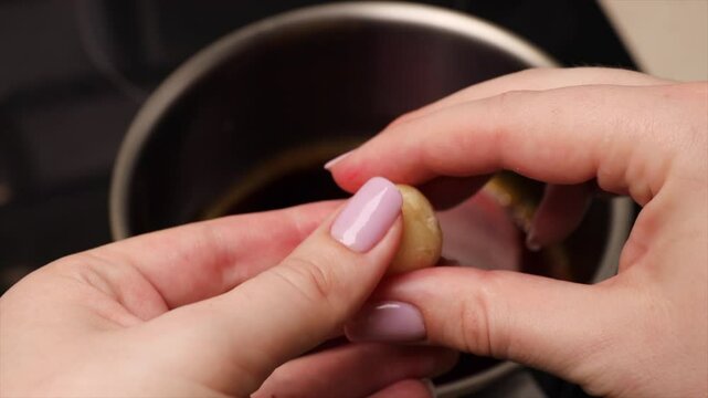 Rolling coconut balls for Brazilian dessert bala baiana. Traditional sweet preparation process.
