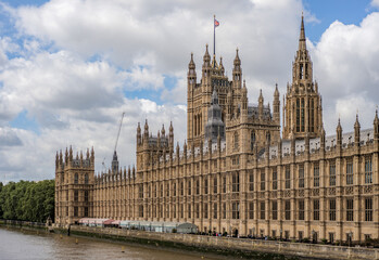 the iconic Palace of Westminster, home to the UK Parliament, with its intricate Gothic architecture along the River Thames.