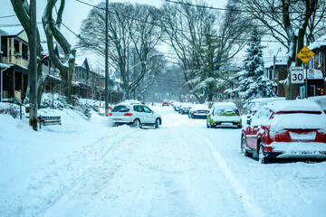 A snow filled residential street being shovelled out after a snow fall. Shot in the Toronto’s Beaches in February.	
