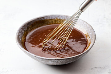 bowl of homemade hoisin sauce on white kitchen table