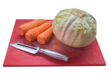 Cabbage carrots and a tumbling knife on a red cutting board isolated on a white background.