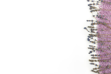 Lavender bath salt and lavender sprigs on it on the right edge of the background