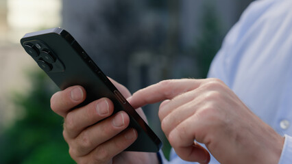 Close up male hands holding mobile phone in city formal unrecognizable businessman business chat...