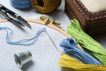 Different sewing supplies for embroidery on table, closeup
