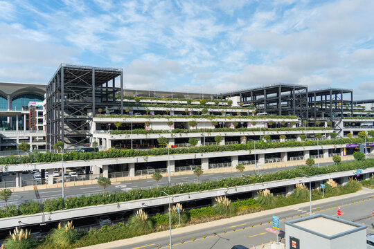 Multi-level parking structure at new Istanbul Airport (IST) under partly cloudy sky.