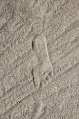 A man's footprint in the sand