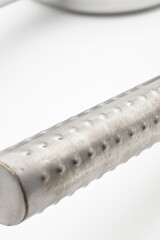 Industrial metal colander, can also be used for household stainless steel water scoop close up on white background