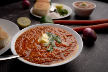 Pav bhaji is a fast food dish from India consisting of a thick vegetable curry served with a soft bread roll