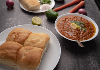 Mumbai Style Pav or paav bhaji is a fast food dish from India, consists of a thick vegetable curry served with a soft bread roll, served in a plate