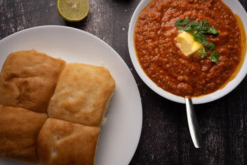 Mumbai Style Pav or paav bhaji is a fast food dish from India, consists of a thick vegetable curry served with a soft bread roll, served in a plate