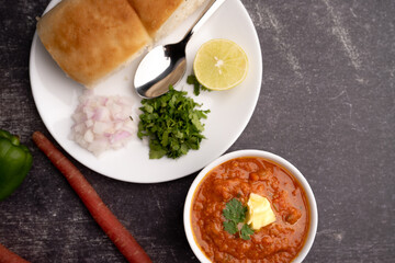 Mumbai Style Pav or paav bhaji is a fast food dish from India, consists of a thick vegetable curry served with a soft bread roll, served in a plate