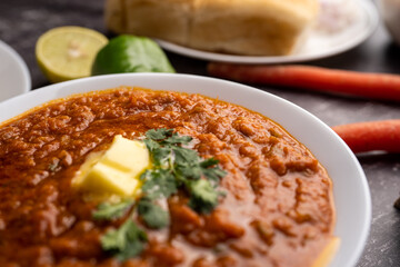 Pav bhaji is a fast food dish from India consisting of a thick vegetable curry served with a soft bread roll