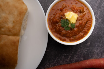 Pav bhaji is a fast food dish from India consisting of a thick vegetable curry served with a soft bread roll