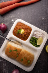 Mumbai Style Pav or paav bhaji is a fast food dish from India, consists of a thick vegetable curry served with a soft bread roll, served in a plate