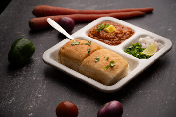 Mumbai Style Pav or paav bhaji is a fast food dish from India, consists of a thick vegetable curry served with a soft bread roll, served in a plate