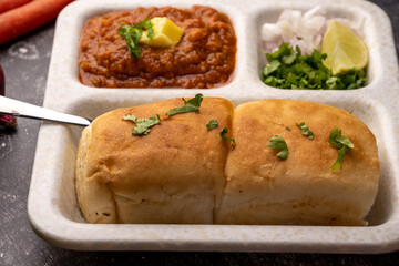 Mumbai Style Pav or paav bhaji is a fast food dish from India, consists of a thick vegetable curry served with a soft bread roll, served in a plate