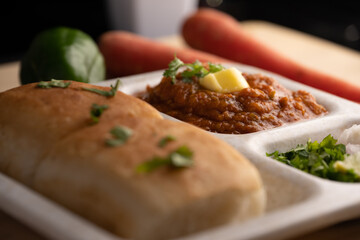 Pav bhaji is a fast food dish from India consisting of a thick vegetable curry served with a soft bread roll