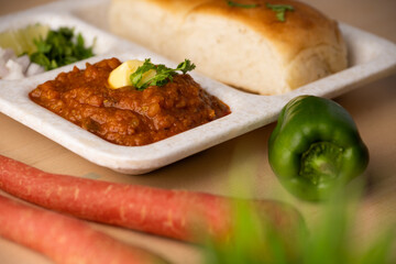 Pav bhaji is a fast food dish from India consisting of a thick vegetable curry served with a soft bread roll