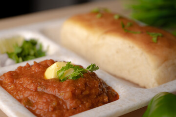 Pav bhaji is a fast food dish from India consisting of a thick vegetable curry served with a soft bread roll
