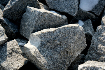 Textured boulders glistening under sunlight in a rocky landscape