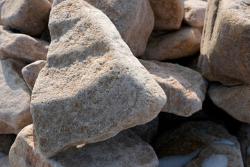 Collection of weathered stones creating a natural sculpture outdoors