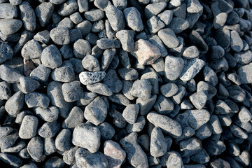 Beautiful black stones create a natural texture in the sunlight