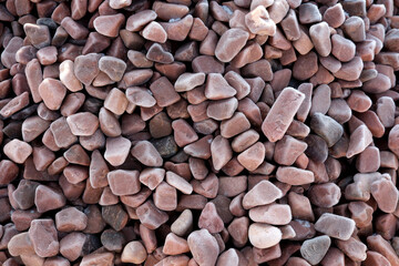 Vibrant collection of smooth pebbles in shades of red and brown