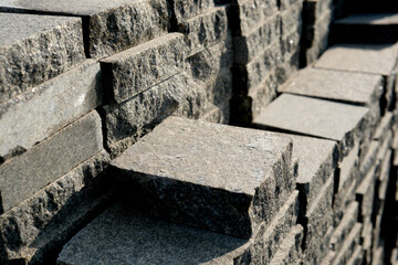 Textured stones arranged meticulously in a sunny worksite