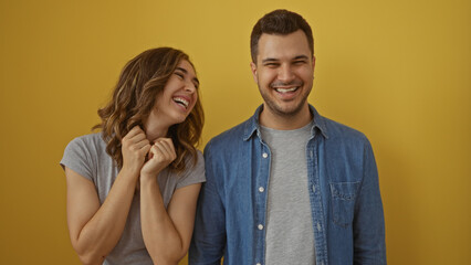 Happy couple standing together smiling over yellow background woman man isolated relationship beautiful joy cheerful