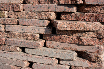 Textured stones create an artistic wall design in natural sunlight