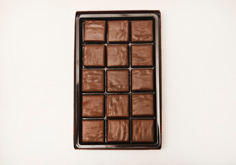Chocolates in a box. A set of candies with white filling.
