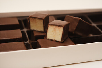Chocolates in a box. A set of candies with white filling.