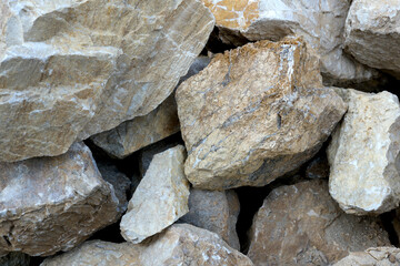 Various rocks resting together at a quarry during daylight hours