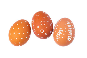 Natural brown Easter eggs with white minimalist patterns isolated on a transparent background