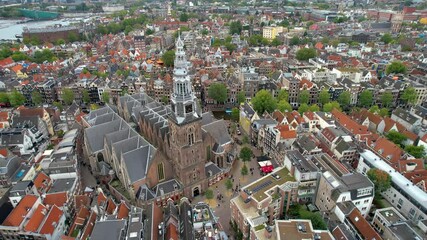 Stunning aerial shot of Oude Kerk Amsterdam showcasing its iconic canals, historic architecture, and vibrant cityscape. 