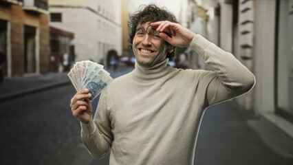 Hispanic man smiling on a city street holding polish zloty banknotes, representing wealth in an...